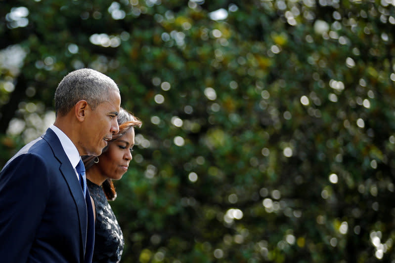 U.S. President Barack Obama walks on the South Lawn of the White House accompanied by first lady Michelle Obama during their departure to Dallas, Texas, in Washington, U.S., July 12, 2016. REUTERS/Carlos Barria