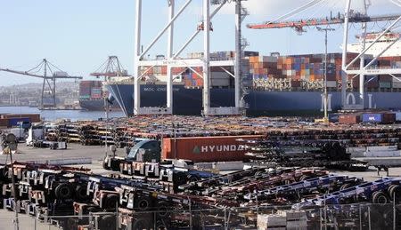 Thousands of cargo carriers sit idle as a ship is unloaded at the Port of Los Angeles October 27, 2014. REUTERS/Bob Riha Jr.