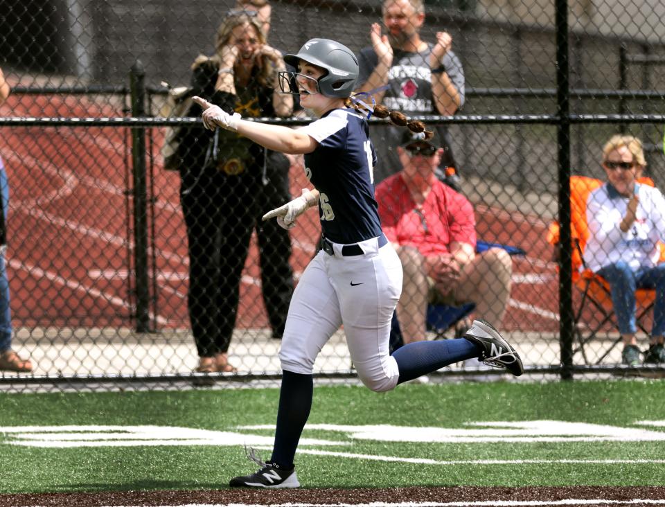 Sutherland's Julianna Lyons celebrates her home run against Mendon in the Class A2 championship.