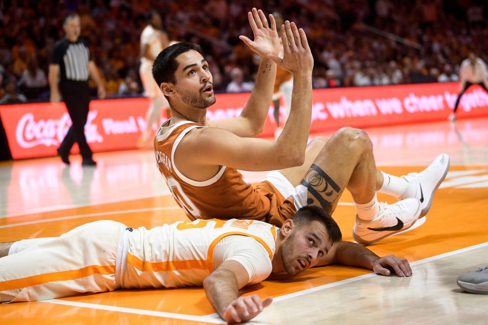 Texas' Brock Cunningham, top, and Tennessee's Santiago Vescovi get tangled up in the paint during the Vols' victory Saturday.