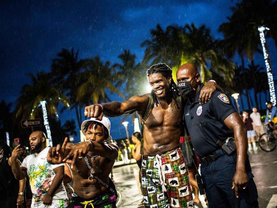 Miami Beach Police escort people off Ocean Drive as curfew is in effect in Miami Beach, Florida, on March 27, 2021