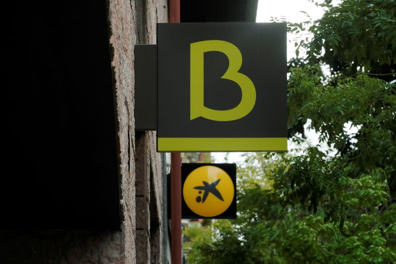 And logo of Bankia and Caixabank are seen in Madrid