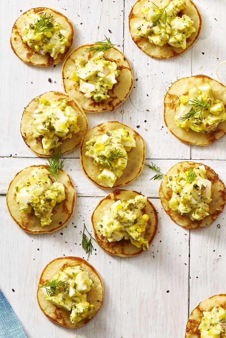 <p>These mini pancakes give you the perfect amount of egg salad per bite, but that won't stop your guests from asking for seconds.</p><p><em><a href="https://www.goodhousekeeping.com/food-recipes/easy/a26767989/egg-salad-blini-bites-recipe/" rel="nofollow noopener" target="_blank" data-ylk="slk:Get the recipe for Egg Salad Blini Bites »;elm:context_link;itc:0;sec:content-canvas" class="link ">Get the recipe for Egg Salad Blini Bites »</a></em></p>