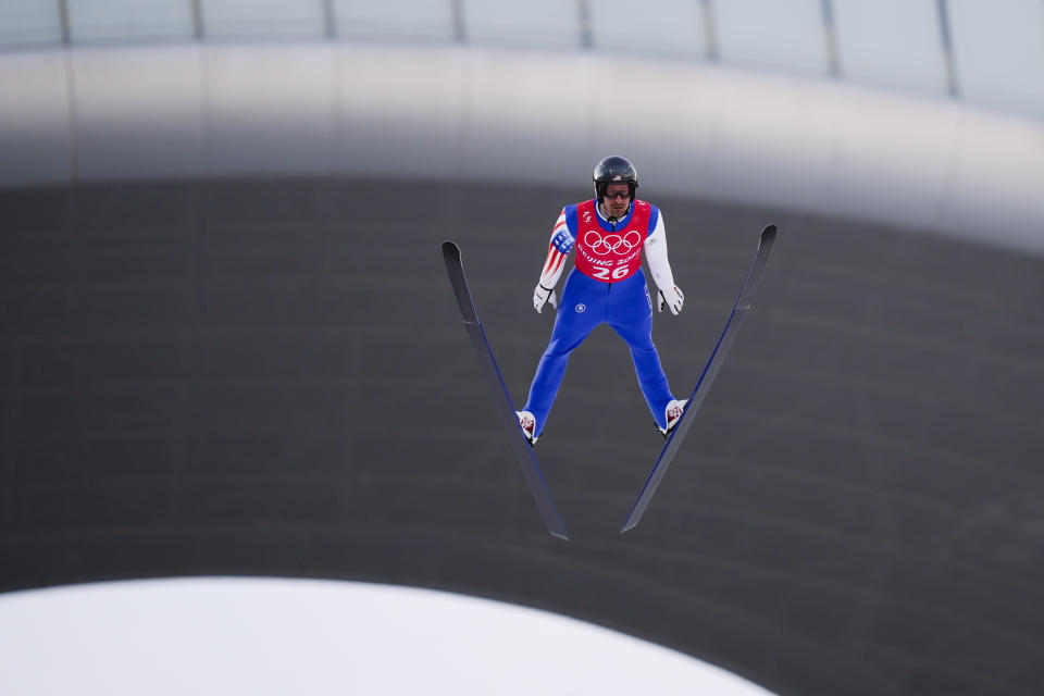 Taylor Fletcher, of the United States, soars through the air during a ski jumping training session in the Gundersen normal hill Nordic Combined event at the 2022 Winter Olympics, Monday, Feb. 7, 2022, in Zhangjiakou, China. (AP Photo/Matthias Schrader)