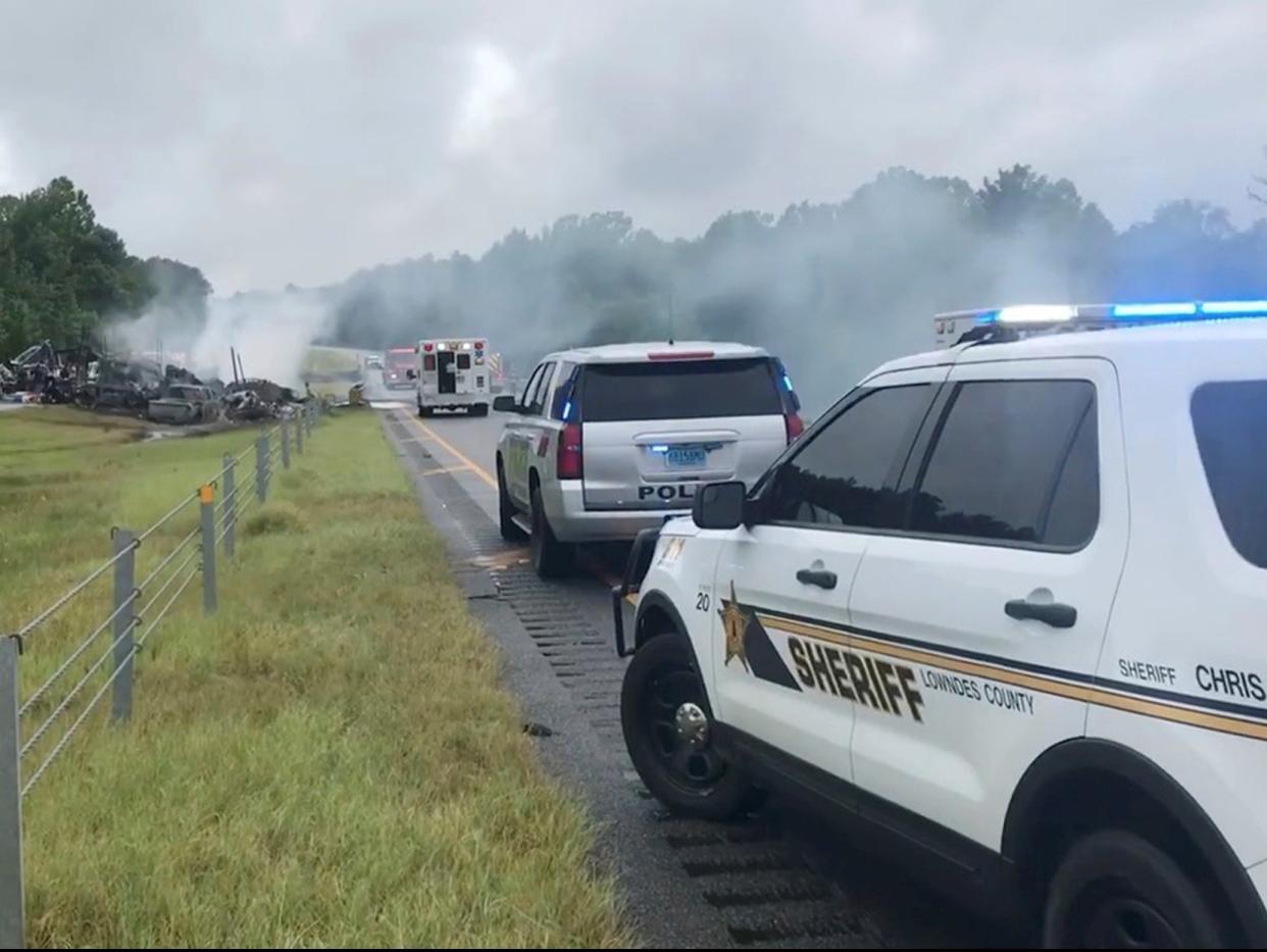 Smoke rises from the wreckage of a collision in Alabama (via REUTERS)