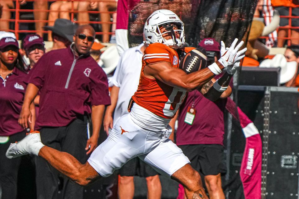 Texas wideout DeAndre Moore Jr. catches a 49-yard pass for a touchdown in Saturday's win over Mississippi State. It was Texas' first SEC game in history and the Horns shrugged off some sloppy play to turn back the 38-point underdogs.