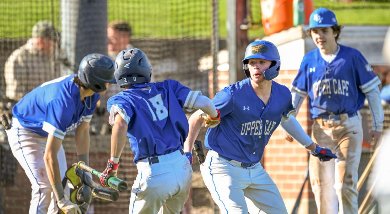 Upper Cape Tech team celebrates with Harrison Gargan (18) after he scored the game winning run on a hit by Tyler Kutil against Sturgis.