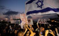 Protesters hold signs and shout slogans against the wedding of groom Mahmoud Mansour, 26, and bride Maral Malka, 23, outside a wedding hall in Rishon Lezion, near Tel Aviv August 17, 2014. Israeli police on Sunday blocked more than 200 far-right Israeli protesters from rushing guests at the wedding of a Jewish woman and Muslim man as they shouted "death to the Arabs" in a sign of tensions stoked by the Gaza war. Picture taken August 17, 2014. To match MIDEAST-ISRAEL/WEDDING REUTERS/Ammar Awad