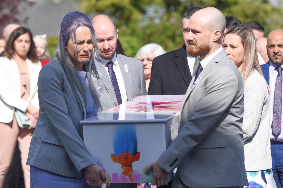 Violet's grieving parents at her funeral (Iain Watts/Mercury Press) 