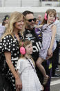 Jimmie Johnson, center, gathers next to his car with his wife Chandra Janway, left, and children Genevieve, front left, and Lydia, right, before the NASCAR Daytona 500 auto race at Daytona International Speedway, Sunday, Feb. 16, 2020, in Daytona Beach, Fla. (AP Photo/John Raoux)