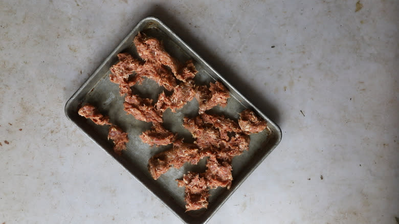 Raw sausage on sheet tray