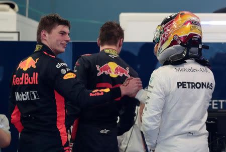 Formula One - F1 - Australian Grand Prix - Melbourne, Australia - 25/03/2017 Red Bull Racing driver Max Verstappen of the Netherlands (L) congratulates Mercedes driver Lewis Hamilton of Britain after the qualifying session. REUTERS/Jason Reed