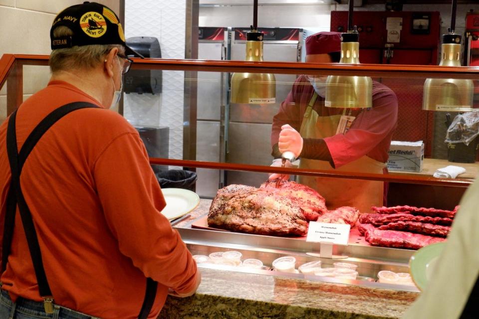 A patron at the Garden Buffet waits for a cut of prime rib.