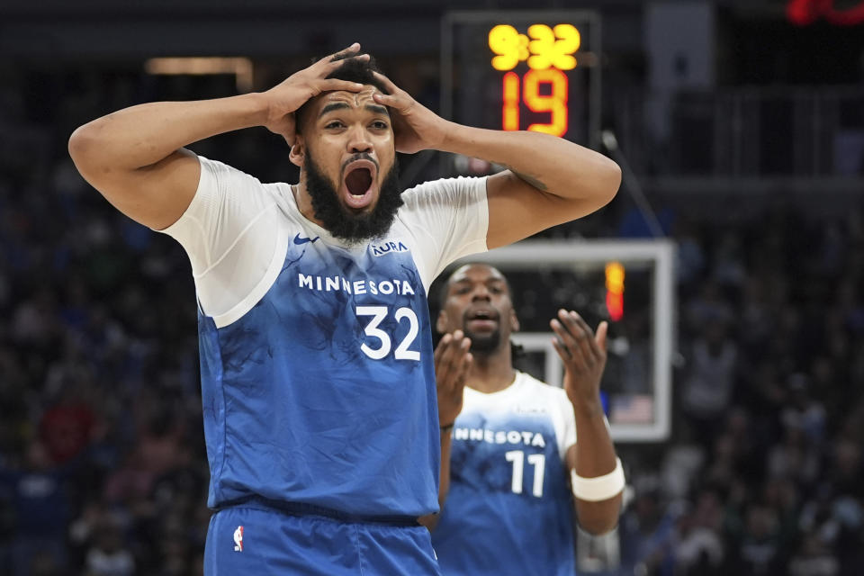 Minnesota Timberwolves centers Karl-Anthony Towns (32) and Naz Reid (11) react after a foul called on forward Jaden McDaniels during the first half of the team's NBA basketball game against the Oklahoma City Thunder, Saturday, Jan. 20, 2024, in Minneapolis. (AP Photo/Abbie Parr)