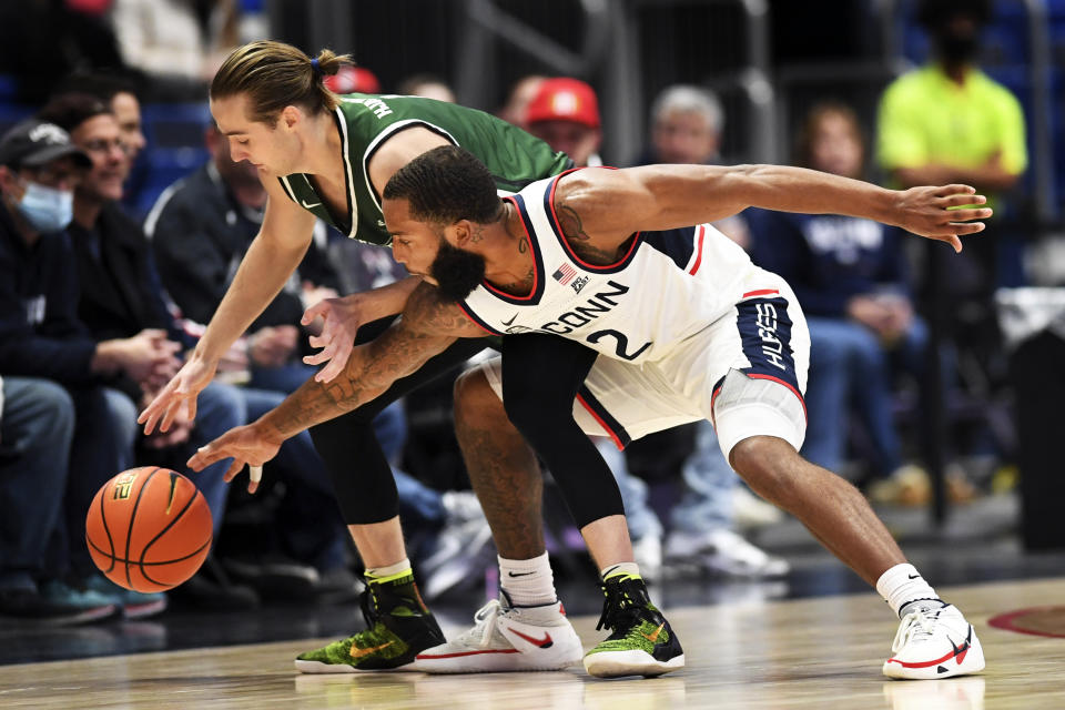 Connecticut's R.J. Cole (2) attempts a steal against Binghamton's Hakon Hjalmarsson (1) during the first half of an NCAA college basketball game Saturday, Nov. 20, 2021, in Hartford, Conn. (AP Photo/Stephen Dunn)