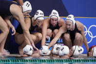 United States players huddle during a timeout in a preliminary round women's water polo match against the Russian Olympic Committee at the 2020 Summer Olympics, Friday, July 30, 2021, in Tokyo, Japan. (AP Photo/Mark Humphrey)