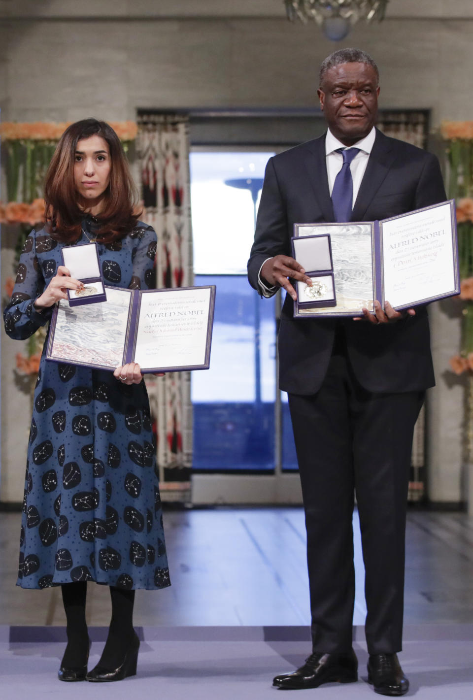 The Peace Prize laureates Dr. Denis Mukwege from Congo and Nadia Murad from Iraq, left, pose with their medals during the Nobel Peace Prize Ceremony in Oslo Town Hall, Oslo, Monday Dec. 10, 2018. Dr. Denis Mukwege and Nadia Murad receive the Nobel Peace Prize recognising their efforts to end the use of sexual violence as a weapon of war and armed conflict. (Haakon Mosvold Larsen / NTB scanpix via AP, Pool)