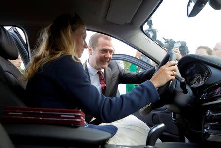 Russian Prime Minister Dmitry Medvedev and synchronized swimmer Natalia Ischenko take part in the awarding of new cars to Russian Olympic medallists returning home from the 2016 Rio Olympics in Moscow's Kremlin, Russia, August 25, 2016. REUTERS/Maxim Shemetov