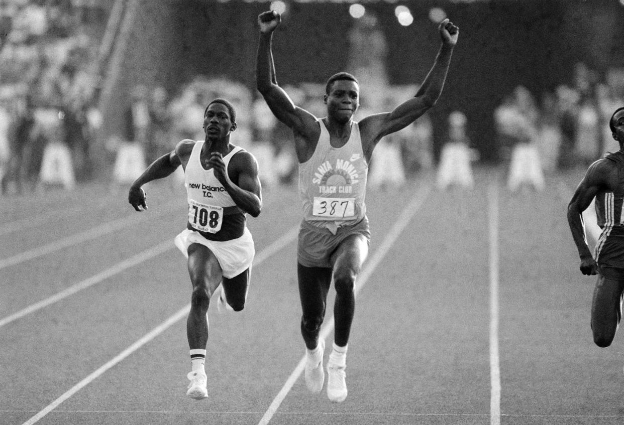 FILE - U.S. athlete Carl Lewis raises his arms in victory as he wins the 100-meter final ahead of third-place Emmit King, left, at the U.S. Olympic track and field trials at the Coliseum in Los Angeles, June 18, 1984. A former University of Alabama track star and Olympian was killed in a shootout with another man, authorities say. The Jefferson County Coronerâ€™s Office on Monday, Nov. 29, 2021, identified Emmit King and Willie Albert Wells as the two men who died after exchanging gunfire in Bessemer on Sunday, AL.com reported. King, 62, was a sprinter and a member of the U.S. relay team for the Summer Olympics in 1984 and 1988, but he didnâ€™t compete. (AP Photo/Lennox McLendon, File)