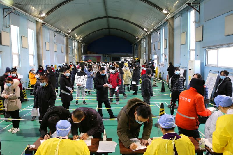 People line up to receive vaccine against COVID-19 at a sports centre in Beijing's Haidian district