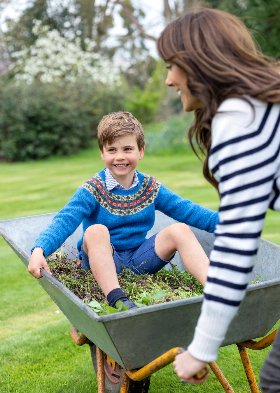 Prince Louis, whose fifth birthday is on Sunday, seen in a portrait being pushed in a wheelbarrow by his mother the Princess of Wales taken by Millie Pilkington earlier this month in Windsor, Berkshire. Issue date: Saturday April 22, 2023. (Millie Pilkington / UK Press Association)