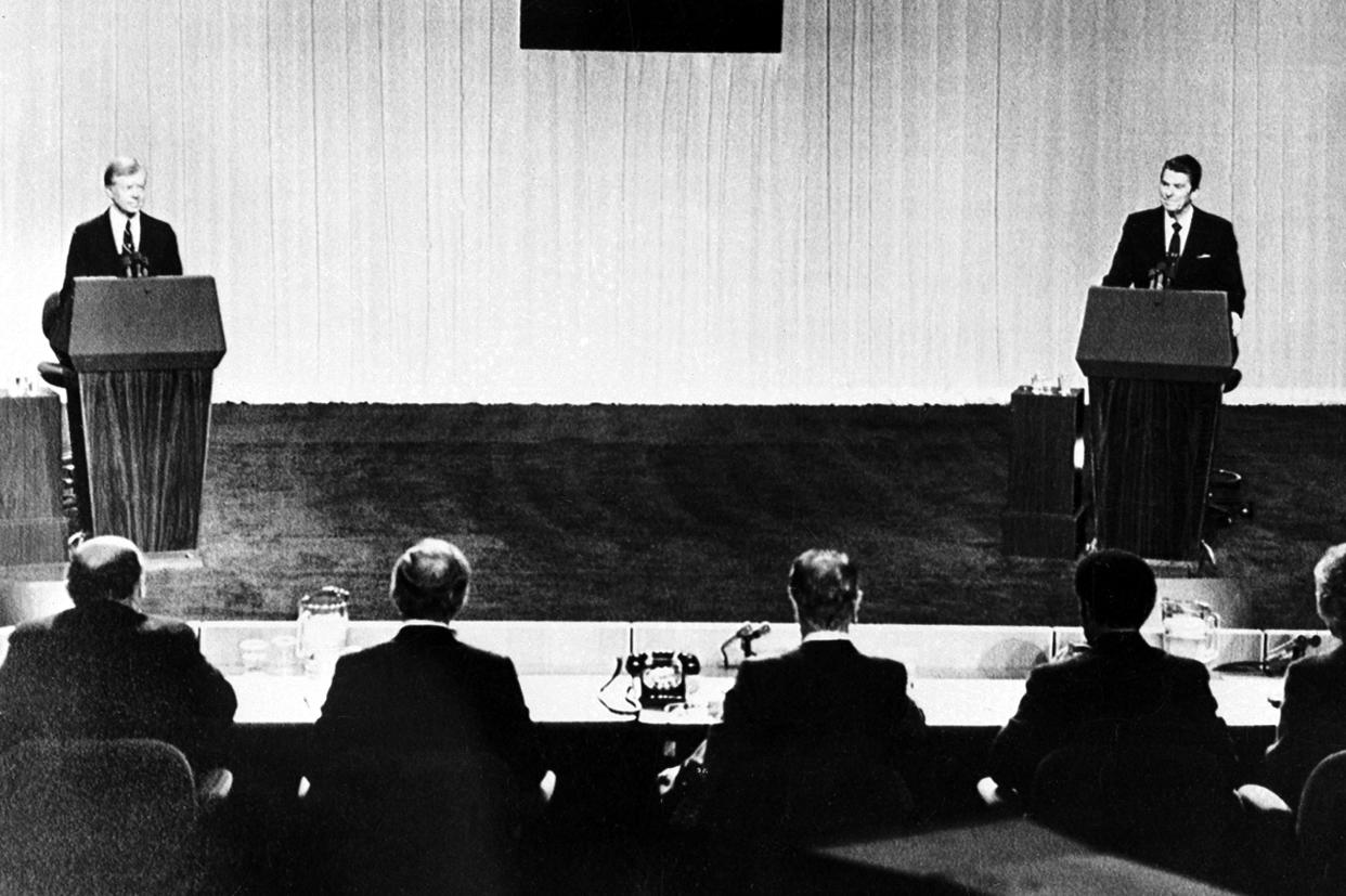 President Jimmy Carter, left, and Republican presidential candidate Ronald Reagan face their panelists during their televised debate at the Cleveland Convention Center in Cleveland, Ohio, on Oct. 28, 1980.   (AP)