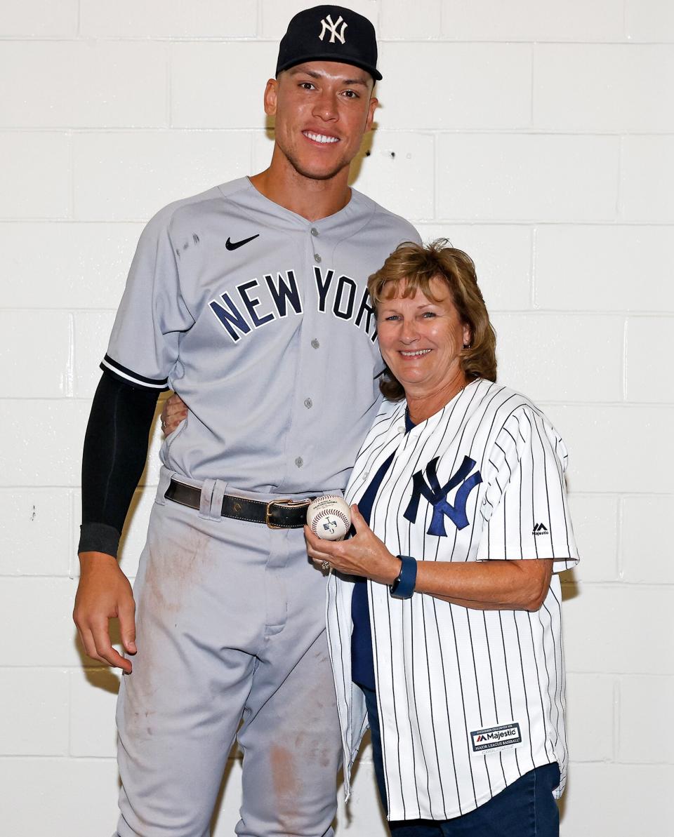 Aaron Judge #99 of the New York Yankees poses for a photograph with his mother, Patty, with the ball he hit to tie Roger Maris American League home run record against the Toronto Blue Jays at Rogers Centre on September 28, 2022 in Toronto, Canada