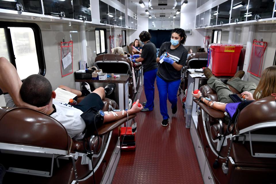 Donors give blood in the Hendrick Regional Blood Center bloodmobile during the 2021 Guns & Hoses drive. The 13th annual event is next week.