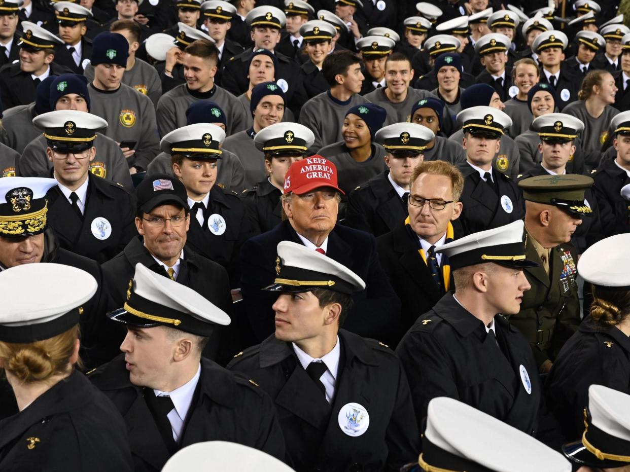 Donald Trump alongside the ex-US Navy secretary Thomas Modly during the Army v Navy  Football game in 2019 (AFP via Getty Images)