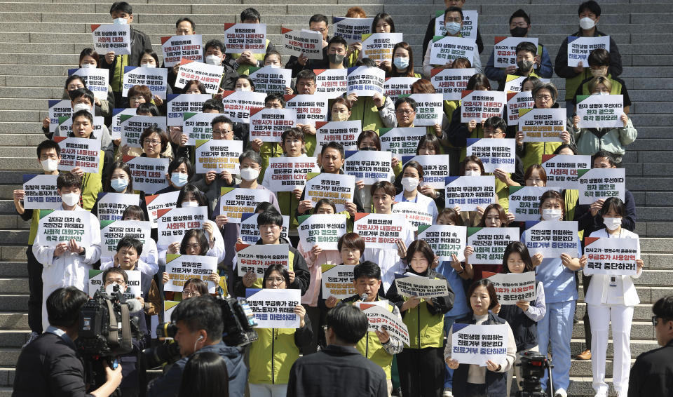 Unionized medical workers stage a rally demanding trainee doctors to return to work in front of Severance Hospital in Seoul, South Korea, Monday, April 1 2024, The signs read, "To promote social dialogue to normalize medical treatment and stop refusing treatment." South Korea's President Yoon Suk Yeol vowed Monday not to back down in the face of vehement protests by doctors seeking to derail his plan to drastically increase medical school admissions, as he called their walkouts "an illegal collective action" that poses "a grave threat to our society."(Kim Sung-min/Yonhap via AP)