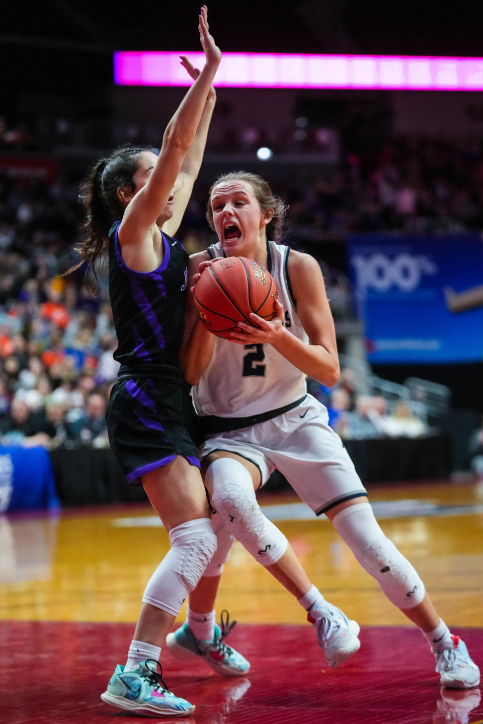 Pleasant Valley guard Jessie Clemons, right, drives to the basket against Johnston guard Isabella Balsley during Friday's Class 5A championship game at Wells Fargo Arena.