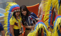 <p>Fans of Japan and Colombia take a picture together </p>