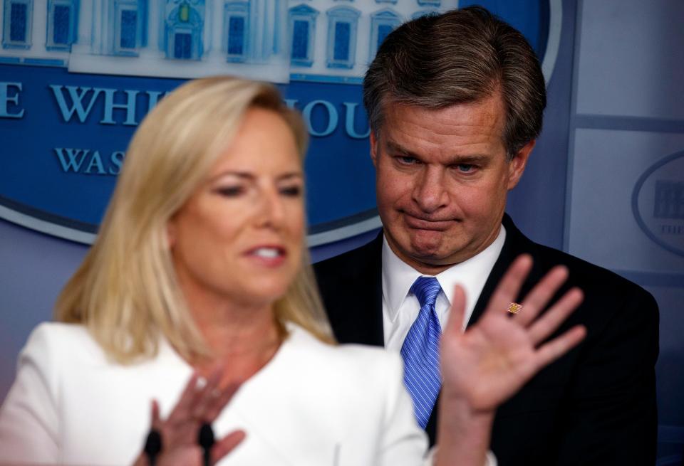 FBI Director Christopher Wray listens as Secretary of Homeland Security Kirstjen Nielsen speaks during the daily press briefing at the White House Aug. 2, 2018, in Washington.