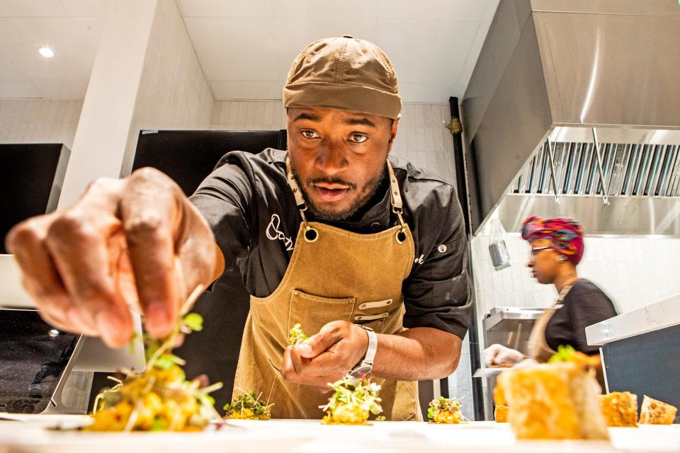 Justin Womack, 38, prepares food at Oath 84 one of the food kiosks at The Chancery Market in Wilmington, Wednesday, Nov. 30, 2022.