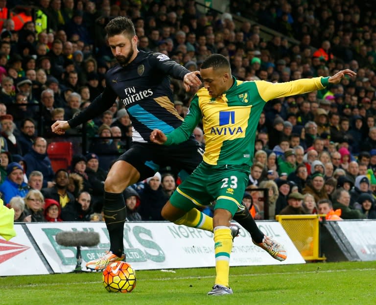 Norwich City's Swedish defender Martin Olsson (R) vies with Arsenal's French striker Olivier Giroud during the English Premier League football match at Carrow Road in Norwich, eastern England on November 29, 2015