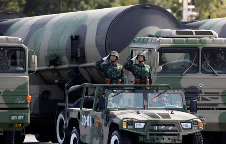 FILE PHOTO - People's Liberation Army (PLA) soldiers salute in front of nuclear-capable missiles during a massive parade to mark the 60th anniversary of the founding of the People's Republic of China in Beijing October 1, 2009. REUTERS/David Gray/File Photo