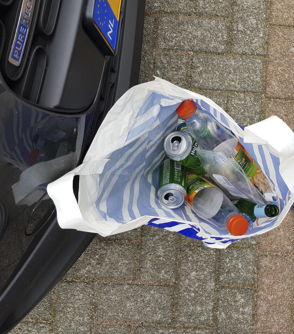 In this image released by the Dutch Defense Ministry on Thursday Oct. 4, 2018, trash belonging to four Russian officers of the Main Directorate of the General Staff of the Armed Forces of the Russian Federation, GRU, is seen next to their car facing the OPCW building on April 13, 2018. The trash was taken not left in their hotel, common practice to avoid leaving finger prints and or DNA, according to the Dutch Defense Ministry. The officers were expelled from the Netherlands for allegedly trying to hack into the chemical watchdog OPCW's network. The Dutch defense minister on Thursday Oct. 4, 2018, accused Russia's military intelligence unit of attempted cybercrimes targeting the U.N. chemical weapons watchdog and the investigation into the 2014 Malaysian Airlines crash over Ukraine. (Dutch Defense Ministry via AP)