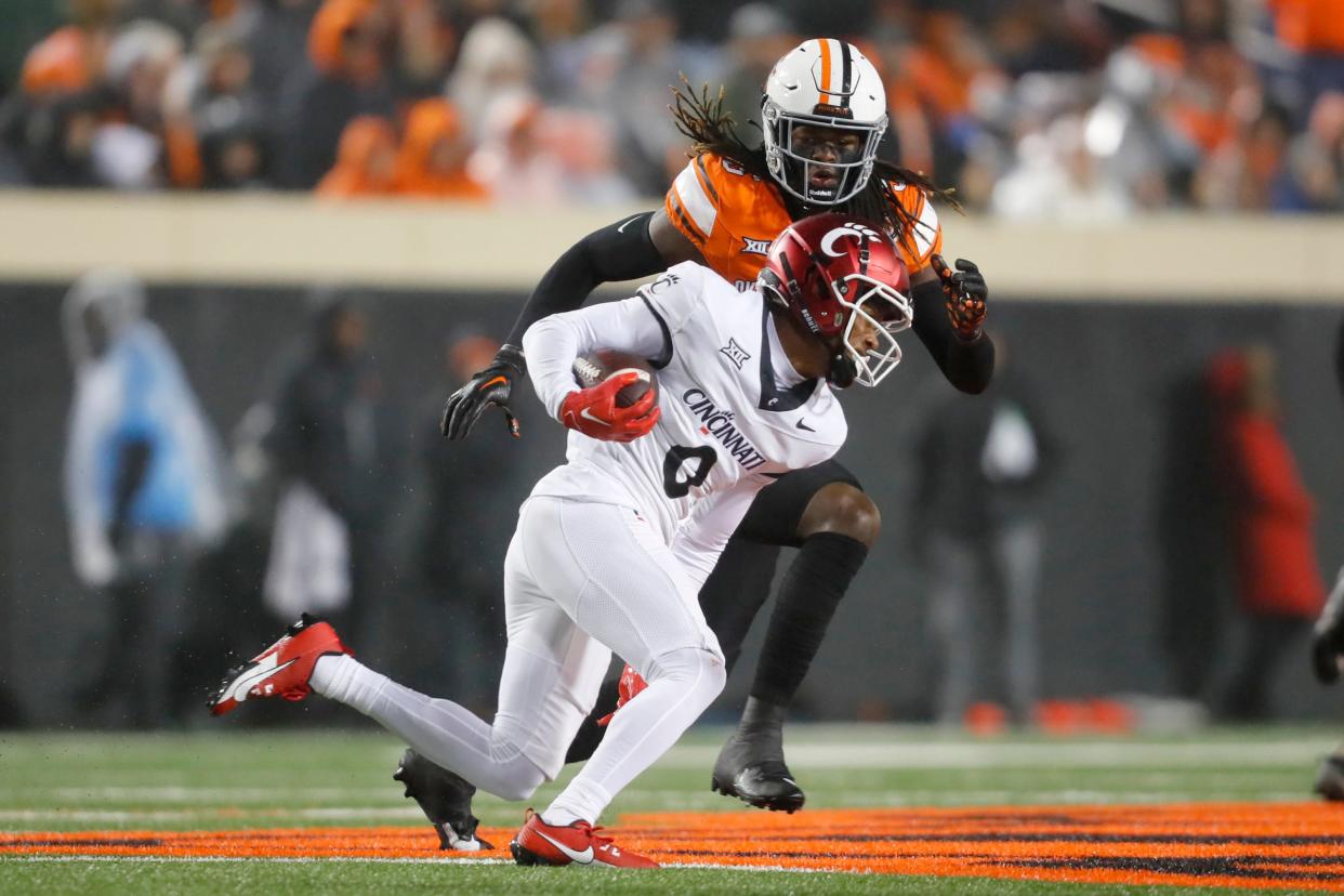 Oct 28, 2023; Stillwater, Oklahoma, USA; Oklahoma State Cowboys safety Kendal Daniels (5) cheses down Cincinnati Bearcats wide receiver Braden Smith (0) during a college football game between Oklahoma State and Cincinnati at Boone Pickens Stadium. Oklahoma State won 45-13. Mandatory Credit: Bryan Terry-USA TODAY Sports