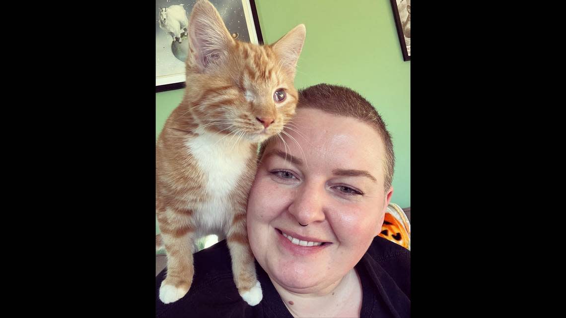 Jessica Means is pictured with Luckee on her shoulders. The orange kitten was adopted Nov. 15 from the Idaho Humane Society in Boise. Jessica Means