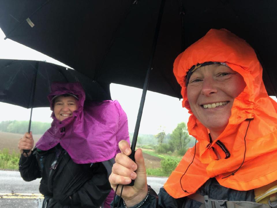 Arlette Laan, right, and Roberta Smith are still smiling as they hike through rain on the Ice Age Trail in northern Wisconsin in May 2022.