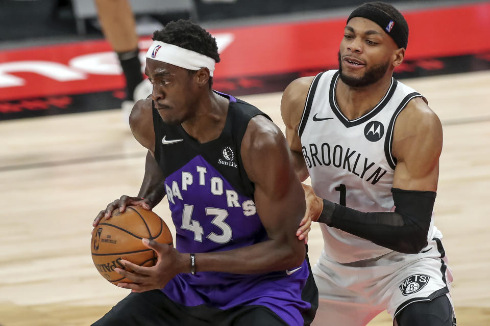 Toronto Raptors' Pascal Siakam, left, is defended by Brooklyn Nets' Bruce Brown during the second half of an NBA basketball game Wednesday, April 21, 2021, in Tampa, Fla. The Raptors won 114-103. (AP Photo/Mike Carlson)