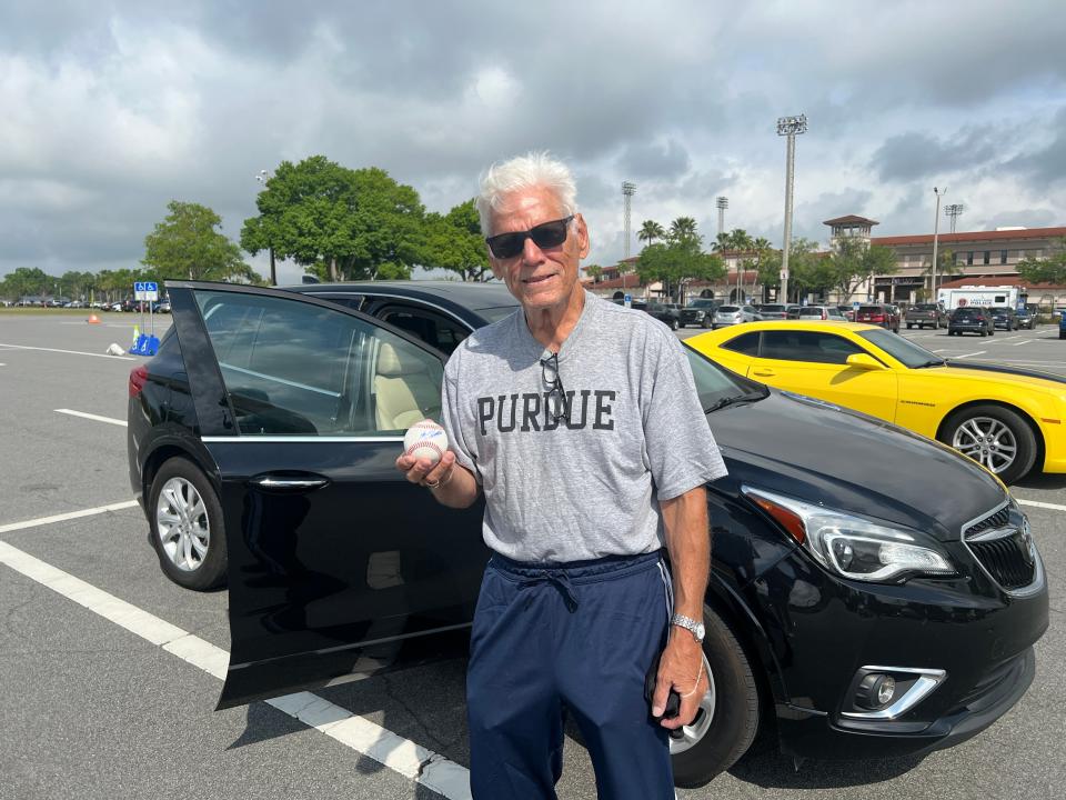 Detroit Tigers fan John Dykes holds a baseball signed by Max Clark in the parking lot at Joker Marchant Stadium on March 16, 2024, in Lakeland, Florida.