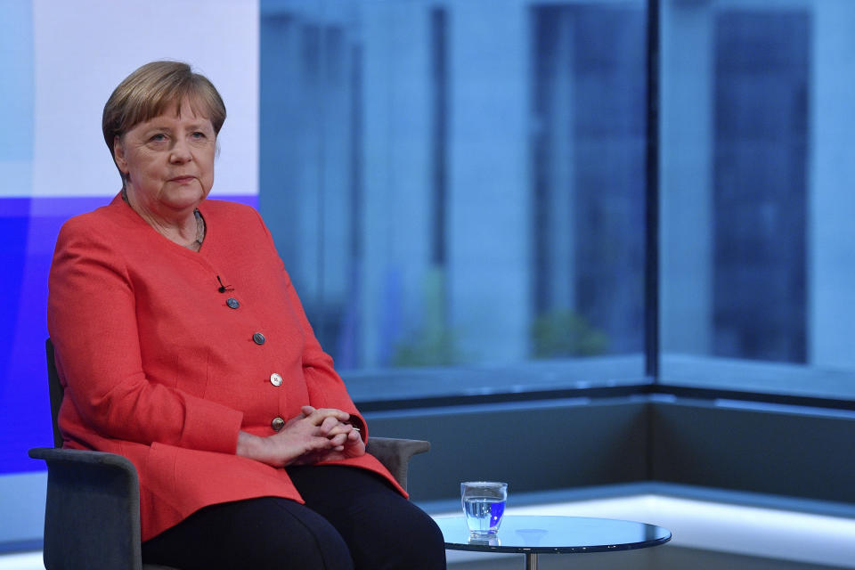 German Chancellor Angela Merkel, left, ahead of a televised interview at the hauptstadtstudio (Capital city studio) of public broadcaster ARD in Berlin, Thursday June 4, 2020. (John MacDougall/Pool via AP)
