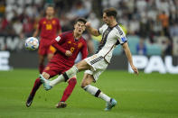 Spain's Gavi, left, challenges for the ball with Germany's Leon Gorentzka during the World Cup group E soccer match between Spain and Germany, at the Al Bayt Stadium in Al Khor , Qatar, Sunday, Nov. 27, 2022. (AP Photo/Julio Cortez)