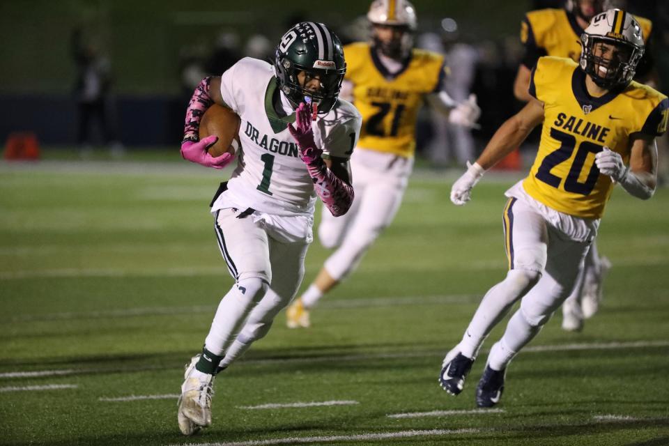 Lake Orion running back Raymond Payne runs the ball against Saline during first-half action at Saline High School on Friday, Oct. 20, 2023.