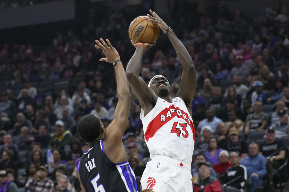 Toronto Raptors forward Pascal Siakam (43) shoots over Sacramento Kings guard De'Aaron Fox, left, during the first quarter of an NBA basketball game in Sacramento, Calif., Friday, Jan. 5, 2024. (AP Photo/Randall Benton)