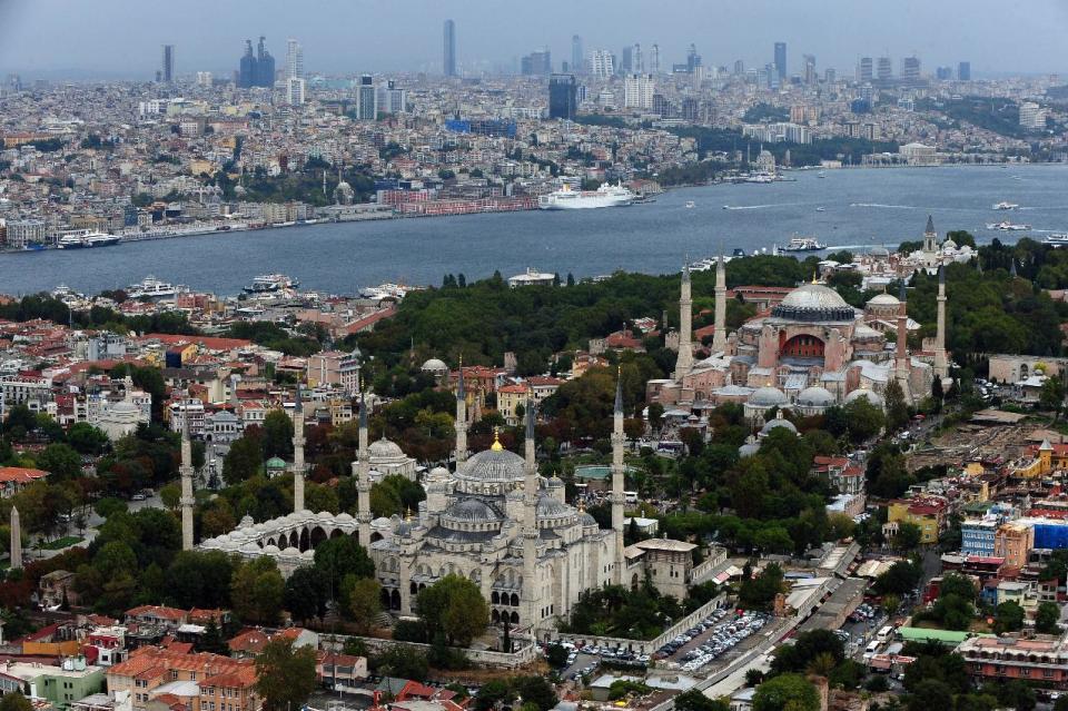 FILE - This Sept. 30, 2011 file photo shows Sultan Ahmed Mosque, better known as the Blue Mosque, left, and Hagia Sophia in the historic Sultanahmet district in Istanbul, Turkey. Last summer, Istanbul’s Taksim Square was the scene of violent confrontations between police and protesters. But protests have faded, and contrary to some lingering perceptions, it’s quite calm now _ except for the normal hustle and bustle found in this vibrant city. And it’s as safe for tourists as it ever was. Istanbul is a thoroughly modern place, but it traces its roots back to 660 B.C. It’s the former seat of the opulent Byzantine and Ottoman empires and is divided into European and Asian sides by the Bosporus Strait, offering a wealth of history and stunning scenery. (AP Photo/File)