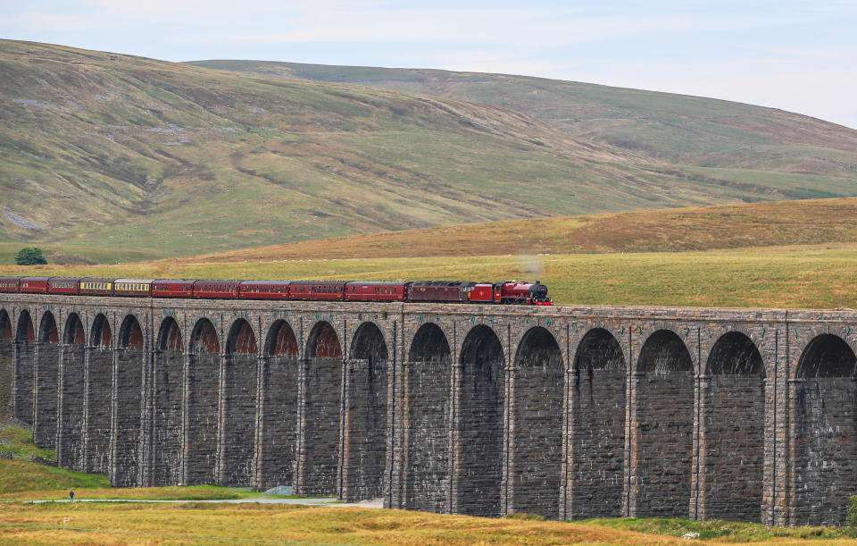 <p>The Cumbrian Mountain Express, pulled by historic steam locomotive No 45699 Galatea, crosses the Ribblehead Viaduct in North Yorkshire as railway enthusiasts mark the 50th anniversary of the end of regular mainline steam services. (PA) </p>