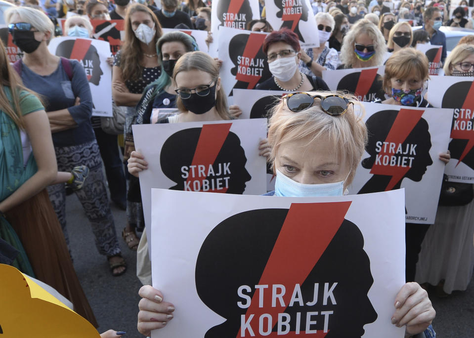 Women with the signs of "Women's Strike" rights organization protest against plans by the right-wing government to withdraw from Europe's Istanbul Convention on prevention of violence against women and children, in Warsaw, Poland, Friday, July 24, 2020 (AP Photo/Czarek Sokolowski)