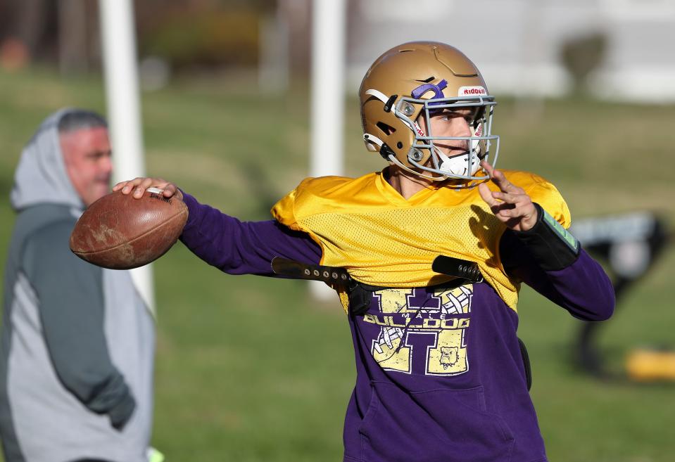 Male High School QB Nic Schutte passes during practice at the school in Louisville, Ky. on Nov. 23, 2021 as they continue to advance in the state tournament.  